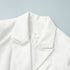 Close-up of tailored collar on women’s white blazer