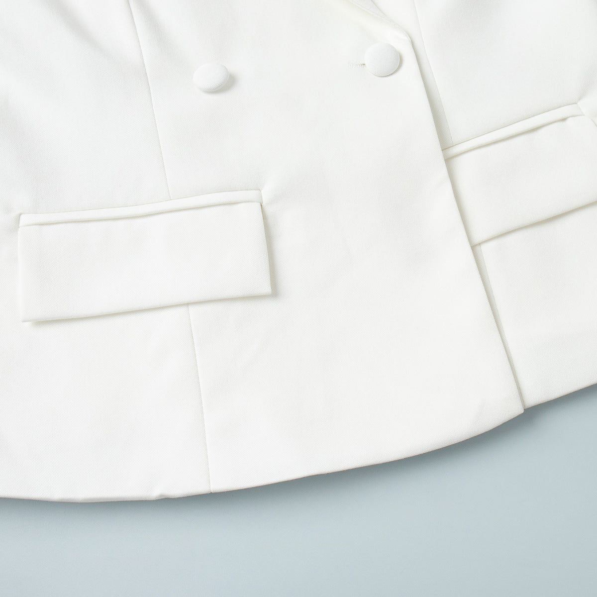 Side pocket design on white tailored blazer