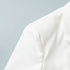 Close-up of shoulder detail of white blazer on a light blue background