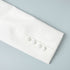 White blazer sleeve cuff with fabric-covered buttons