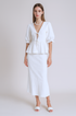 Woman wearing a white skirt set in a plain background