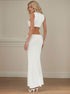 White cut-out maxi dress with high collar, open side design, and fitted long skirt in side-back pose.