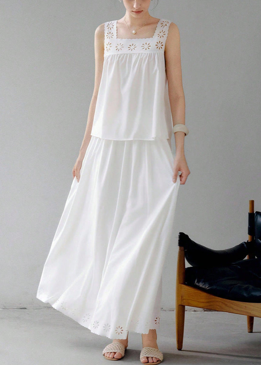 Woman in white two piece set with floral eyelet cutout top and maxi skirt