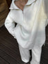 Close-up of white half zip sweater 2 piece set with knit texture