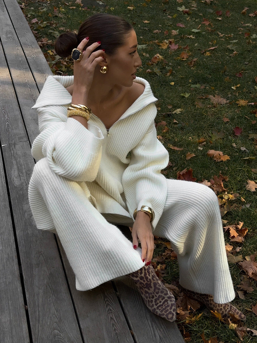 Sitting outdoors in white half zip sweater 2 piece set with wide pants