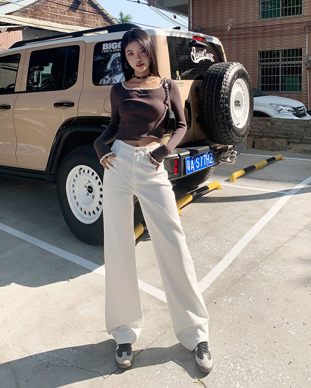 Casual street look with wide-leg white jeans and fitted long-sleeve crop top.