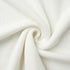 Close-up of white knit sweater fabric texture
