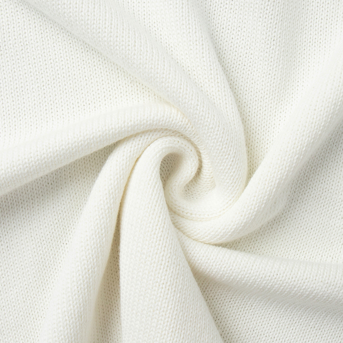 Close-up of white knit sweater fabric texture