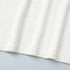 Hemline detail of white knit sweater with clean knit finish