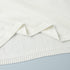 Close-up seam and stitching on white knit sweater