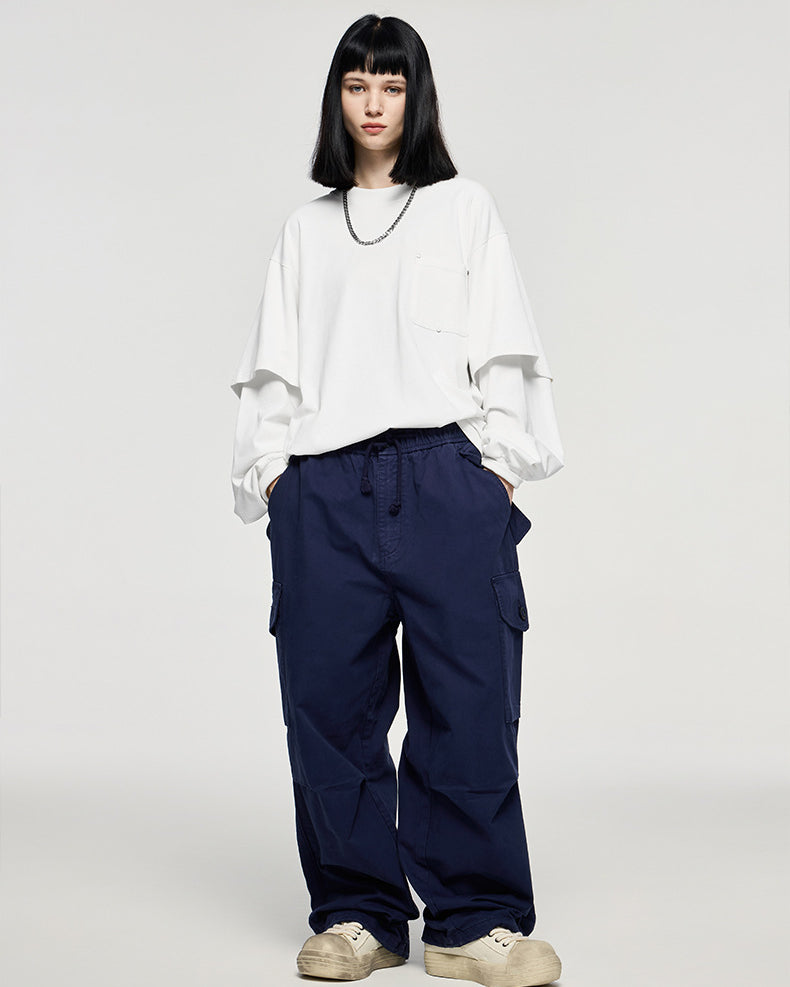 White oversized long sleeve t-shirt men styled with navy pants