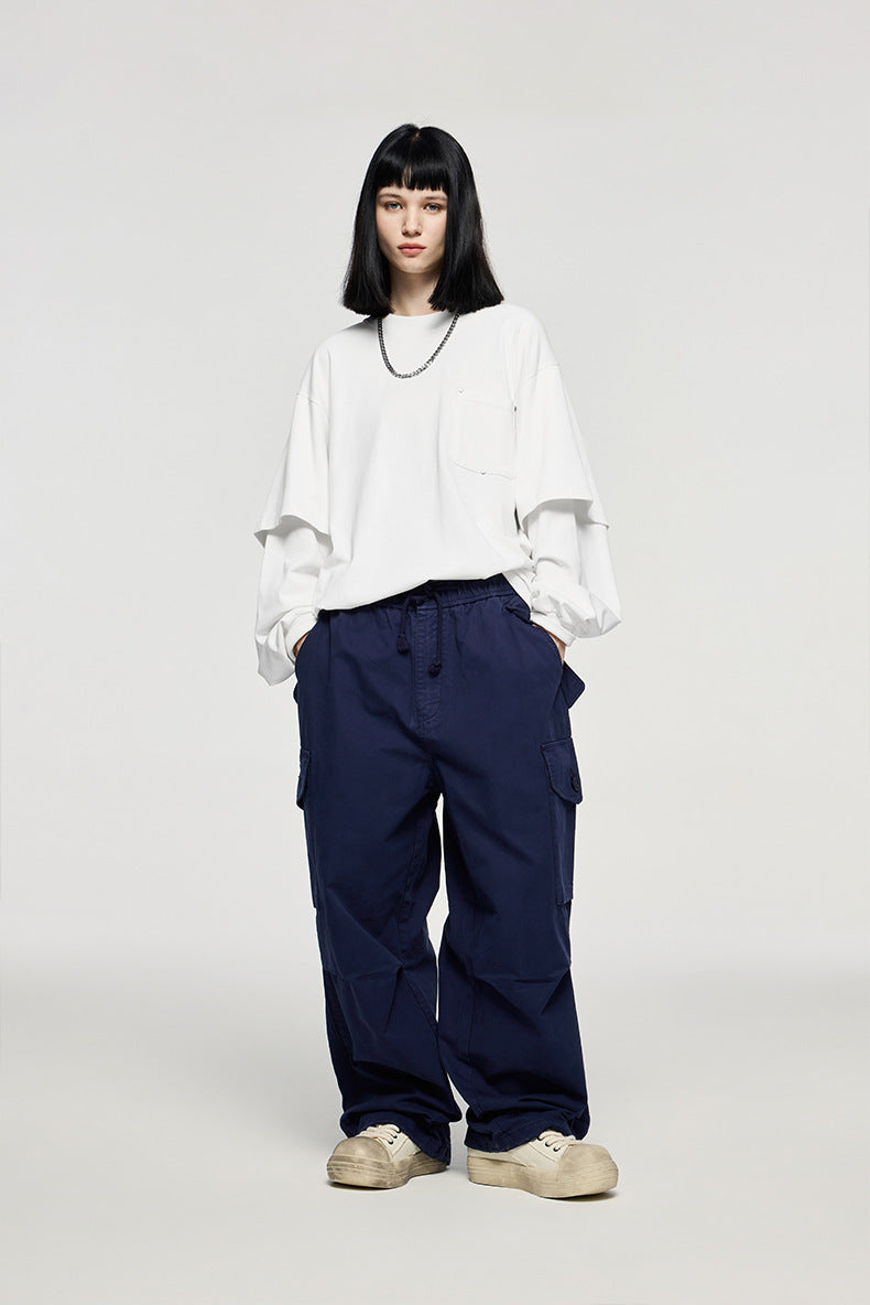 White oversized long sleeve t-shirt men styled with navy pants