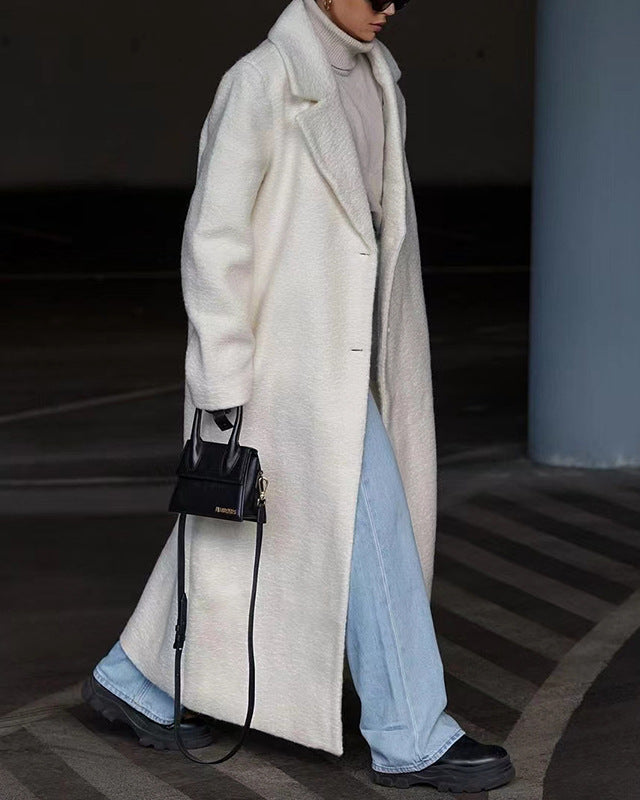 White long teddy lapel coat styled with denim and boots, walking