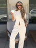 white ribbed crop cardigan and wide leg pants worn by model outdoors