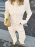 white ribbed co ord set styled with handbag worn by model