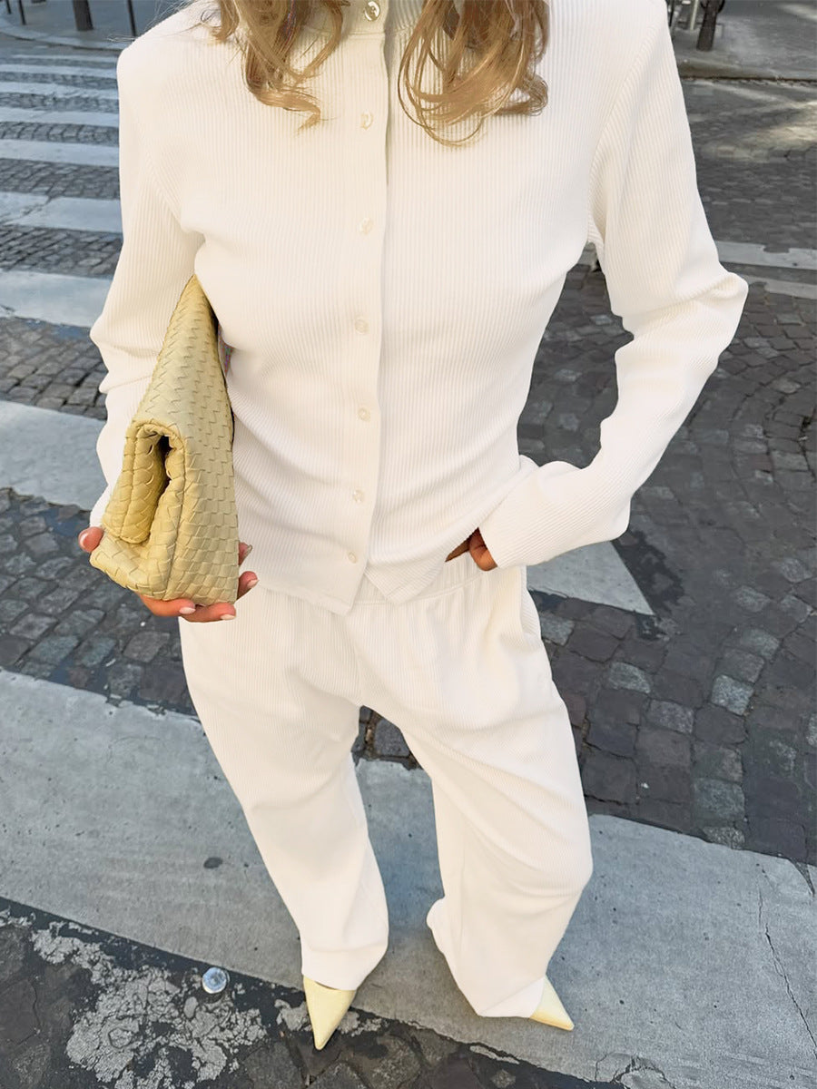 white ribbed co ord set styled with handbag worn by model