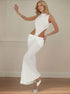 Sexy white dress with high neck and dramatic hollow-out sides highlighting draped knot waist detail.