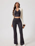 White cropped sports zip up jacket layered over yoga set
