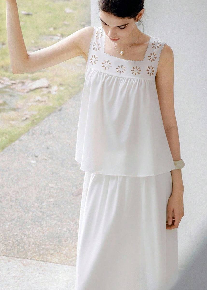 	Woman posing in white cutout two piece set outdoors