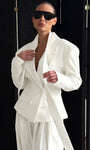 Woman wearing structured white blazer with double-breasted design