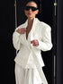 Woman wearing structured white blazer with double-breasted design