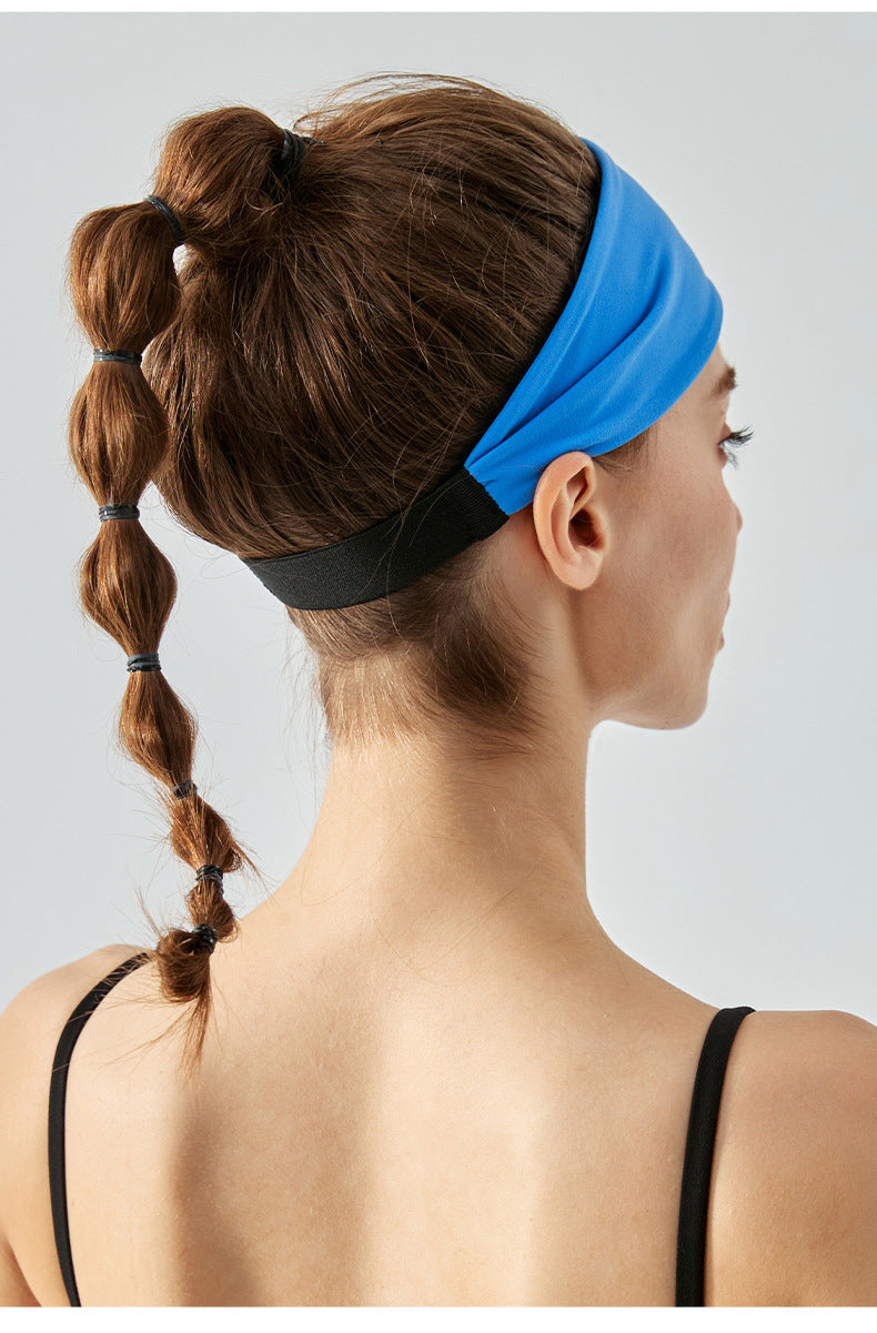 Back view of woman wearing bright blue headband with black elastic band.