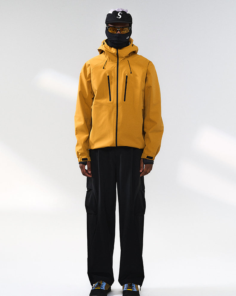 Yellow windbreaker jacket front view on model, hooded and relaxed fit