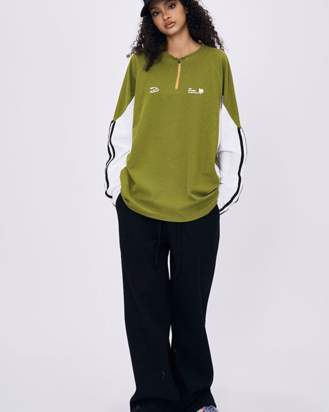Woman wearing green retro contrast color long sleeve t-shirt front view