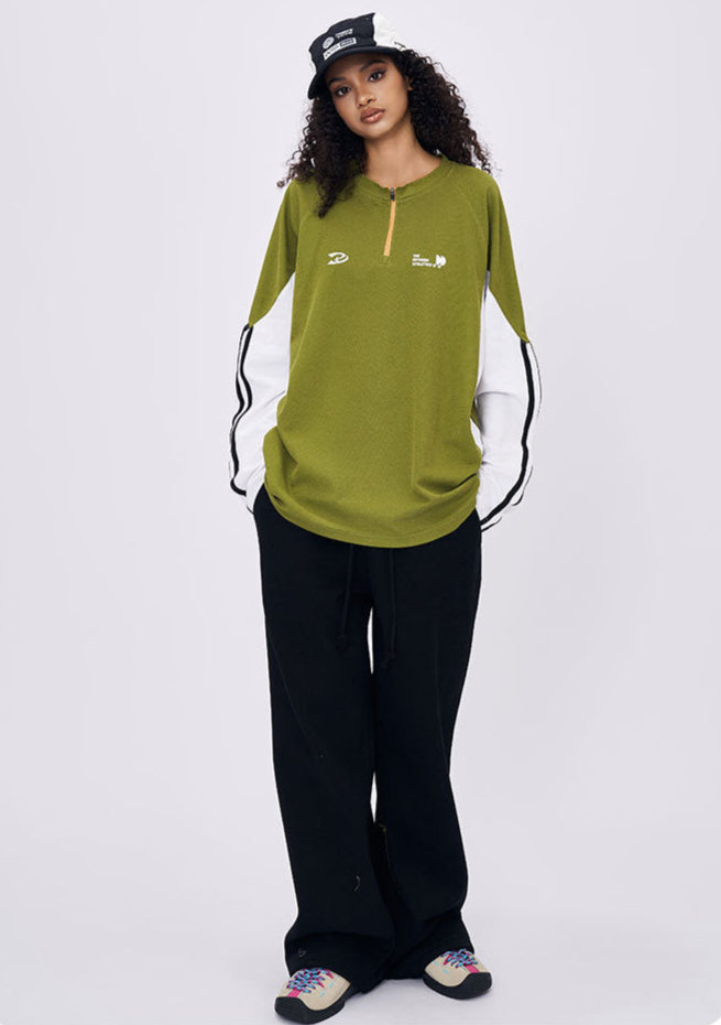 Woman wearing green retro contrast color long sleeve t-shirt front view