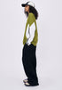 Woman side view in green retro contrast long sleeve t-shirt with zip neckline