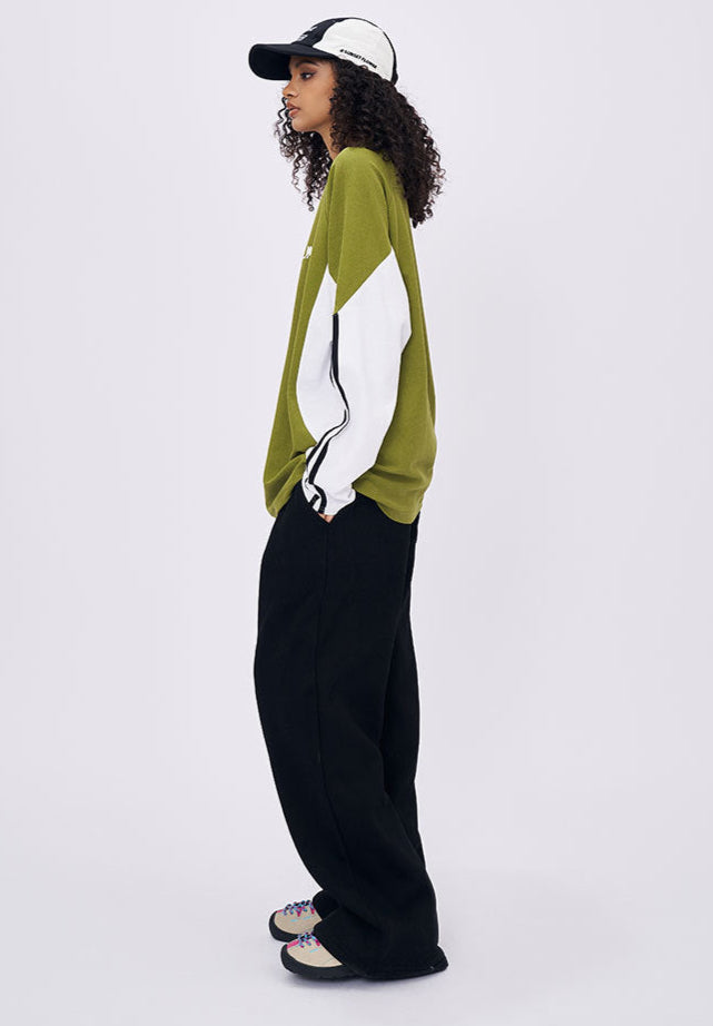 Woman side view in green retro contrast long sleeve t-shirt with zip neckline