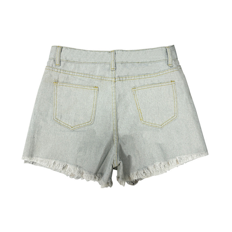 Back view of light wash denim shorts featuring simple back pockets and frayed hems.
