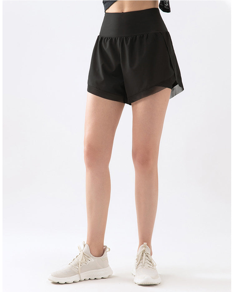 Front view of black athletic shorts on model.
