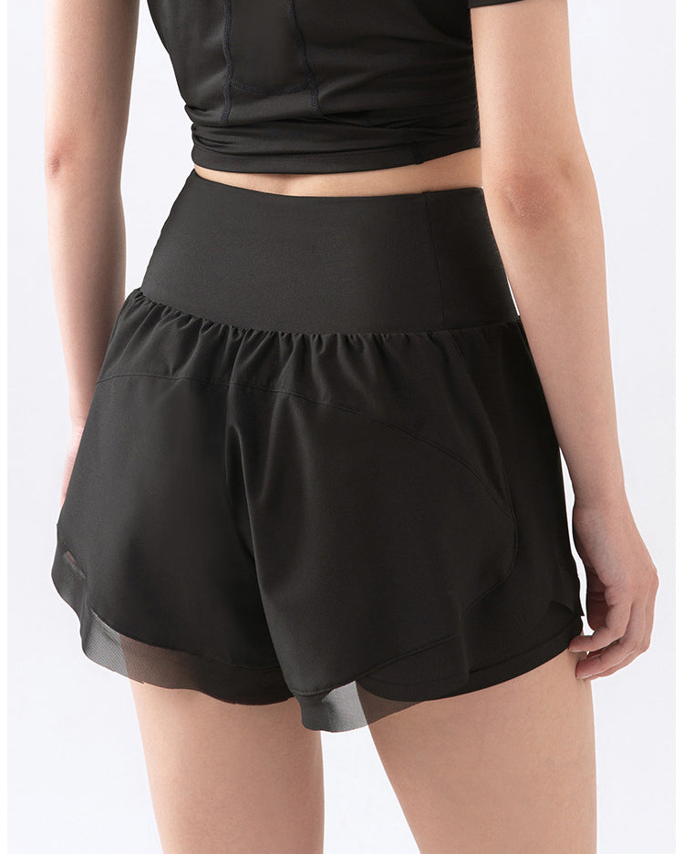 Back view of black athletic shorts on model, close shot.