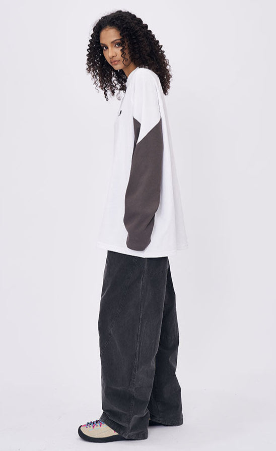 Woman side profile in white retro contrast long sleeve t-shirt with gray sleeves