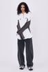 Woman wearing white retro contrast long sleeve t-shirt with casual pants