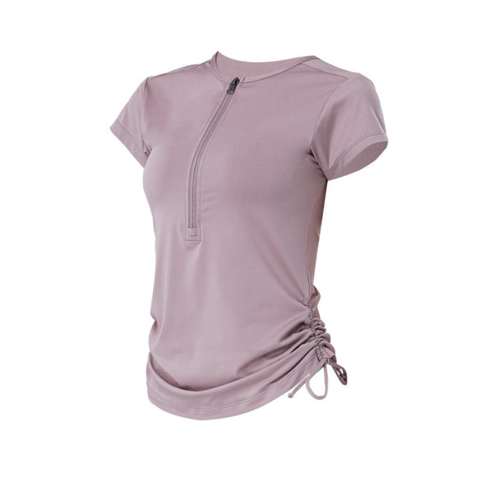 Lavender athletic top with side ruched detail and front zip closure.