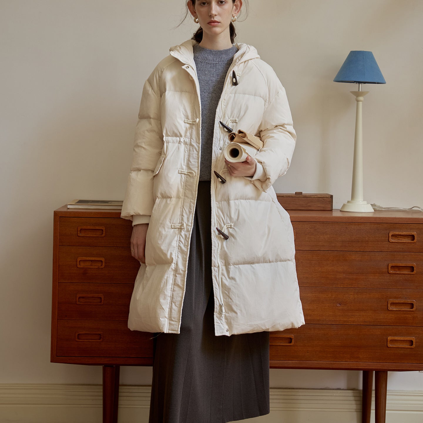 Women’s beige long hooded puffer coat with toggle buttons