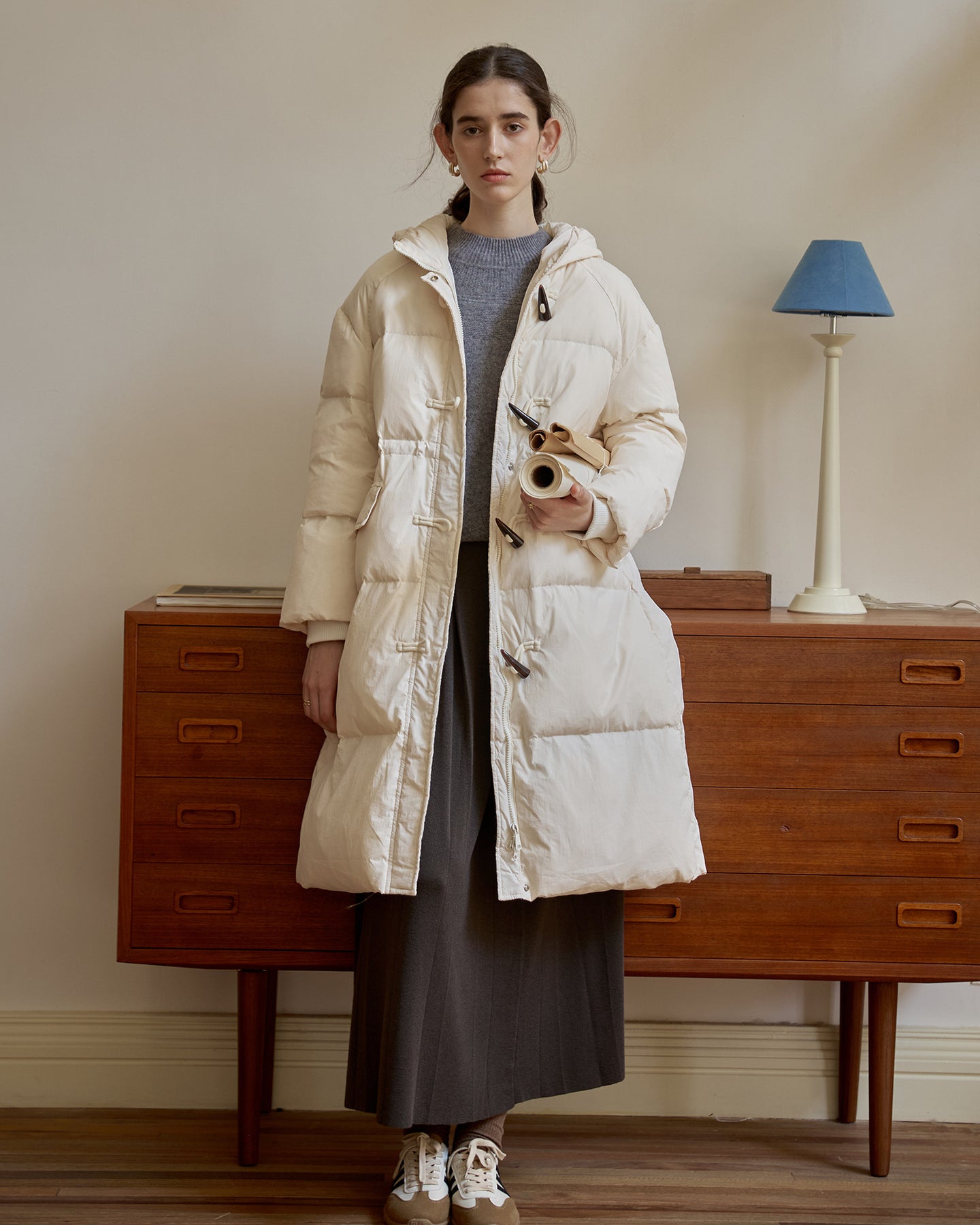 Women’s beige long hooded puffer coat with toggle buttons