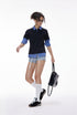 Women’s oversized black layered polo t-shirt with plaid sleeves, chic casual campus fashion look
