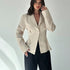 women’s beige blazer, lapel and one-button detail, front pose