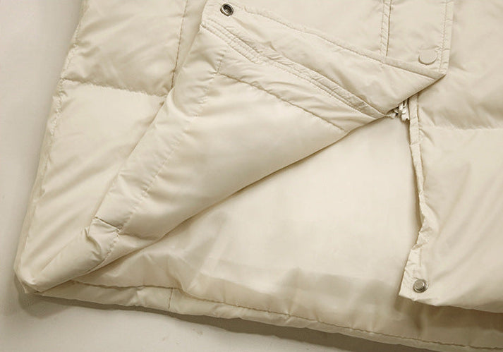 Hem and inner lining detail of cream down long puffer coat