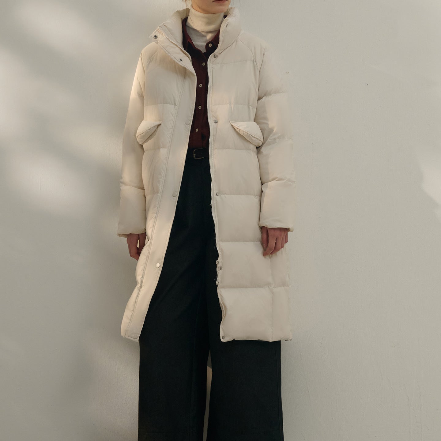 Women’s long cream white puffer coat with high collar and pockets
