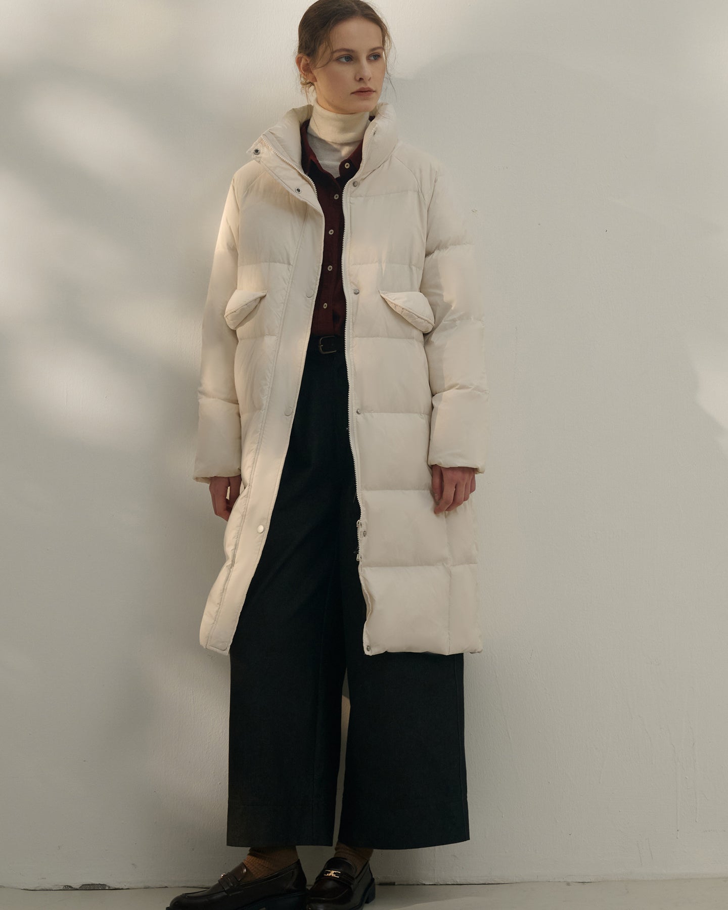 Women’s long cream white puffer coat with high collar and pockets
