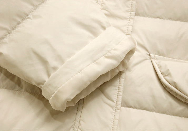 Cuff and sleeve detail of cream women’s long quilted puffer coat