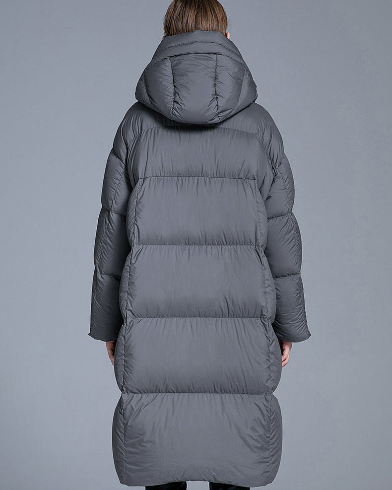 Back view of gray long hooded puffer coat for women with oversized down padding