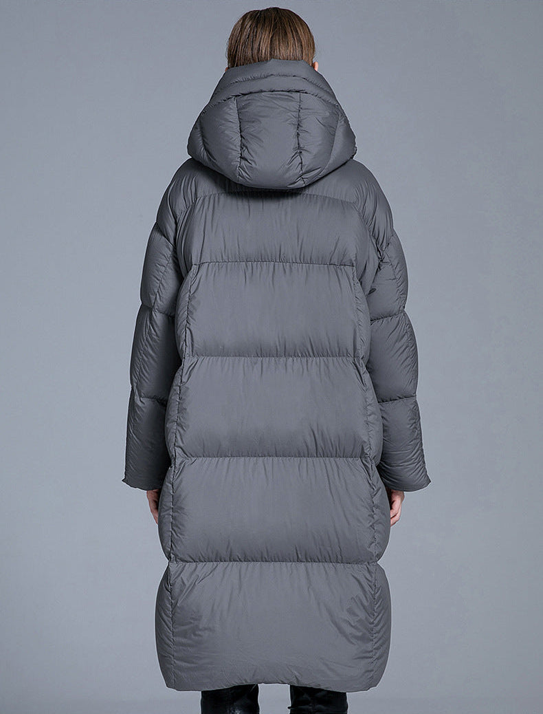 Back view of gray long hooded puffer coat for women with oversized down padding