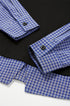 Close-up of cuff and button detail on women’s layered polo t-shirt with plaid sleeves, streetwear style