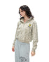 Three-quarter angle shot of a model in a leopard print cropped zip-up hoodie and grey sweatpants.