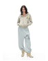 Front full body view of a model styled in a leopard print cropped zip hoodie and casual sweatpants.